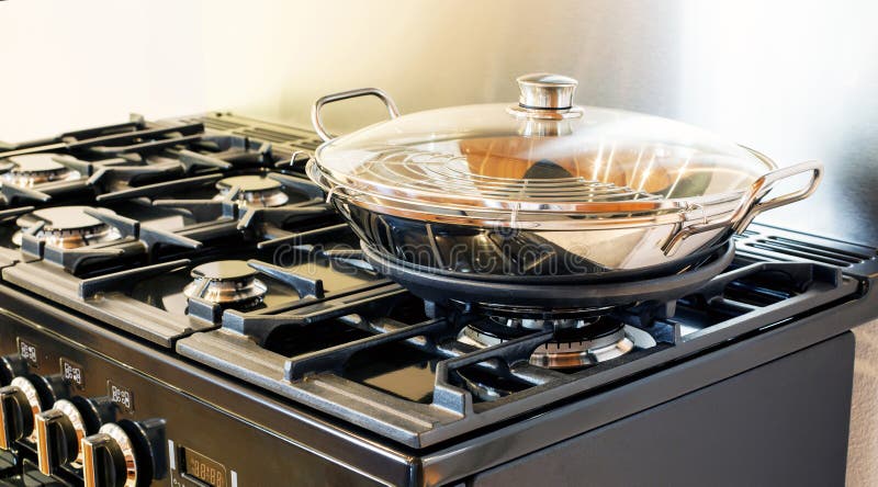 Pot on stove. Pot with glass lid on stove royalty free stock photo
