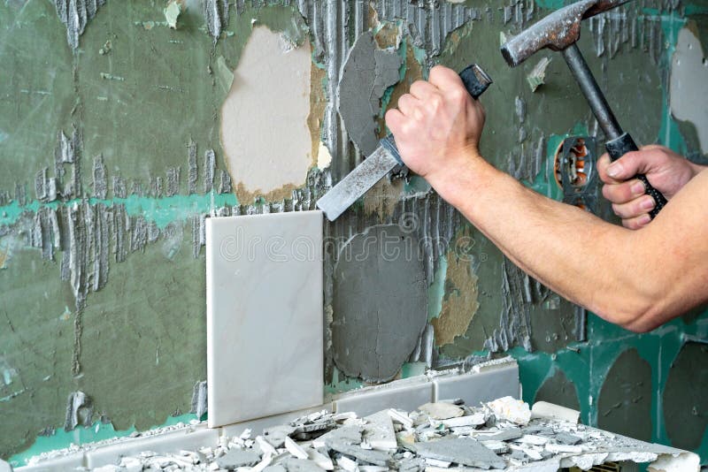 Preparation of repair the bathroom. Man Removing old tiles.  royalty free stock images