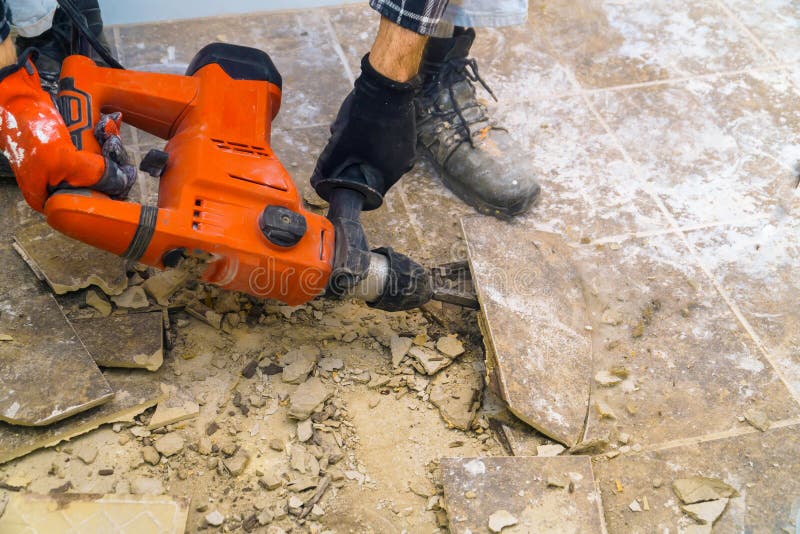 Preparation of repair the bathroom. Removing old tiles. With jackhammer renovation demolition house construction concrete interior work home demolish tool royalty free stock image