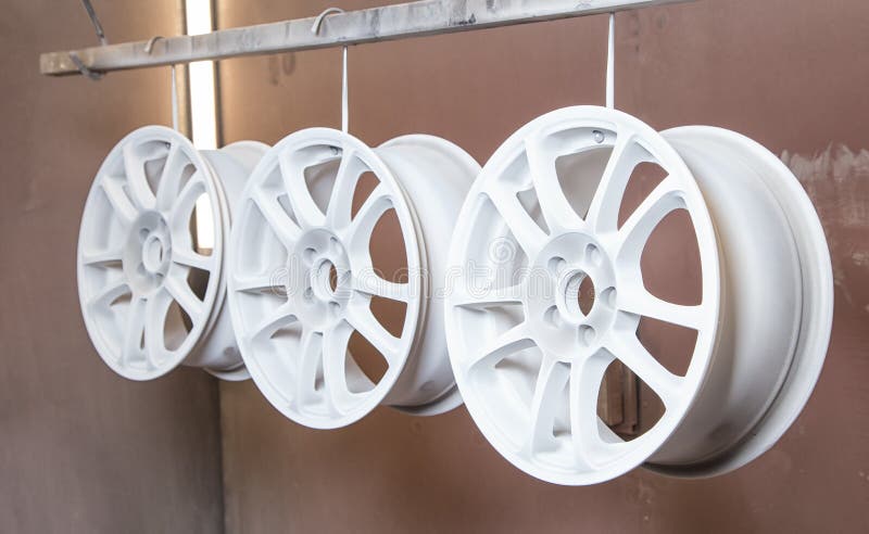 Process of powder coating auto wheels stock photo