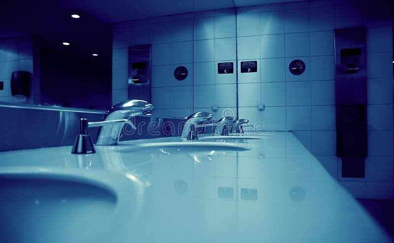 Public toilet room. Clean sterile airport public toilet room with taps royalty free stock image