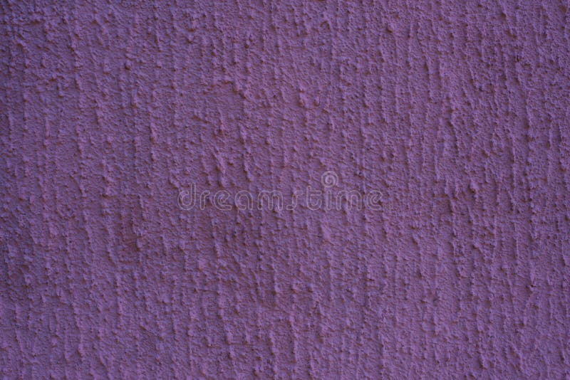 Purple plaster wall. Uneven texture of putty on the wall with copy space.  stock photography