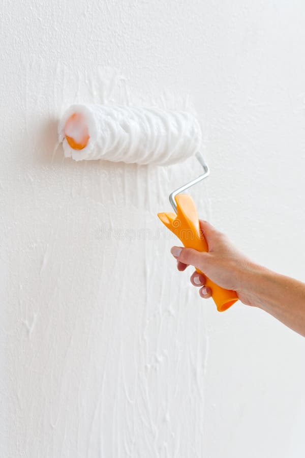 Putting glue on th a wall royalty free stock images