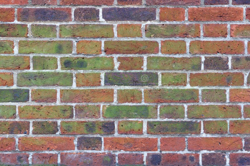 Red Brick Wall Texture. Texture of moss and black stains on old red brick wall stock photos