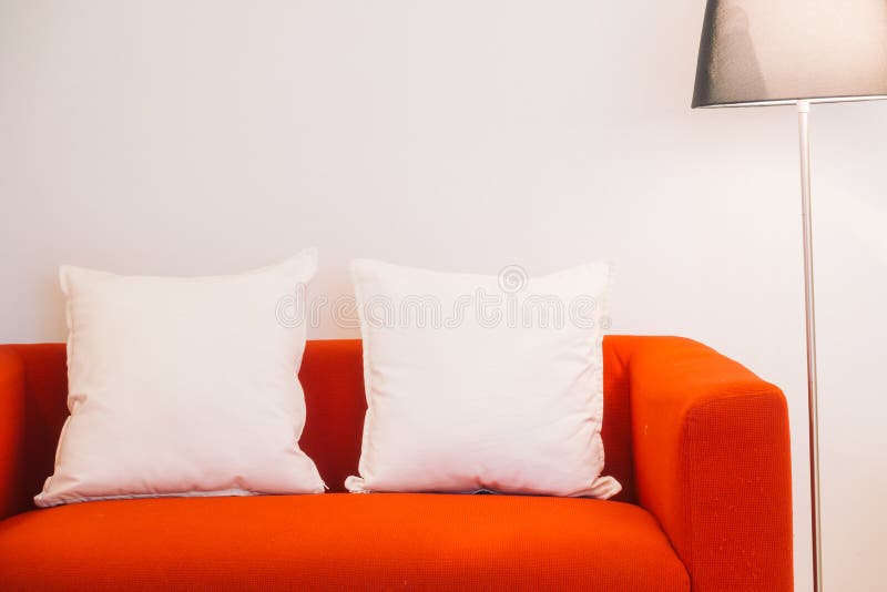 Red sofa with pillow and light lamp. Decoration in living room interior - Vintage Light Filter stock photography Red sofa with pillow and light lamp. Decoration in living room interior - Vintage Light Filter stock photography