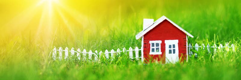 Red wooden house on the grass. Red wooden house model on the grass in garden royalty free stock photo