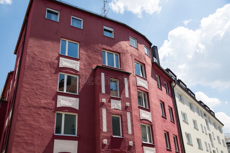 Renovated old building, red facade, rental apartments, condominiums. Munich stock photography