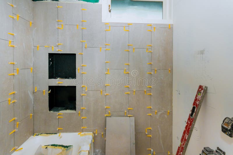 Renovation construction laying floor and wall tile reconstruction of bathroom royalty free stock photography