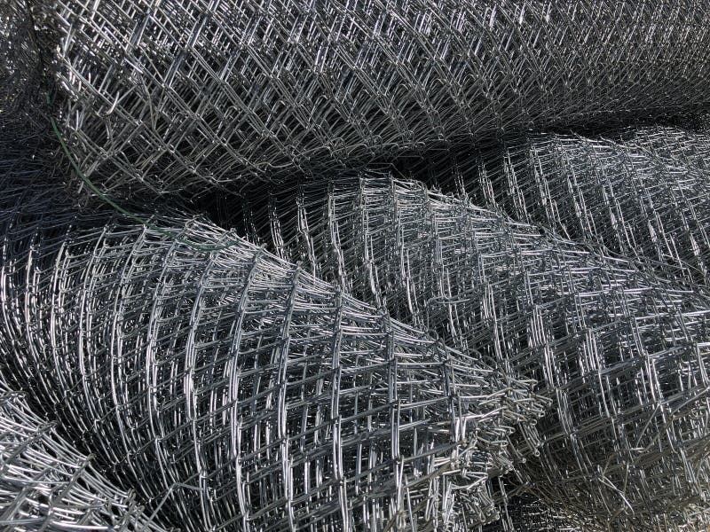 Rolled chain-link fence. Metal mesh netting rolled into rolls.  stock photo