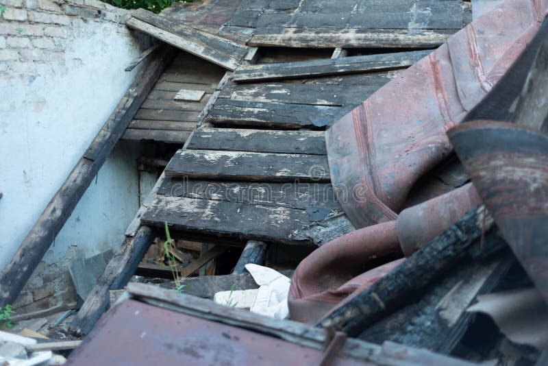 The roof of the burnt building collapsed. Debris filled the room of the house. Ruins, white brick, wall, texture, wallpaper,. Disaster Vintage Abandoned Damaged royalty free stock image