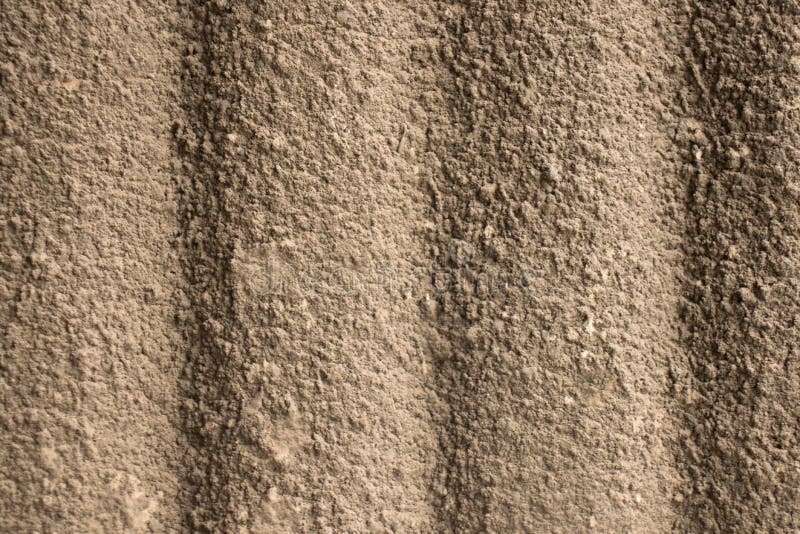 Rough plastered building facade. The appearance of the roughly plastered surface of the facade of the bulding stock image