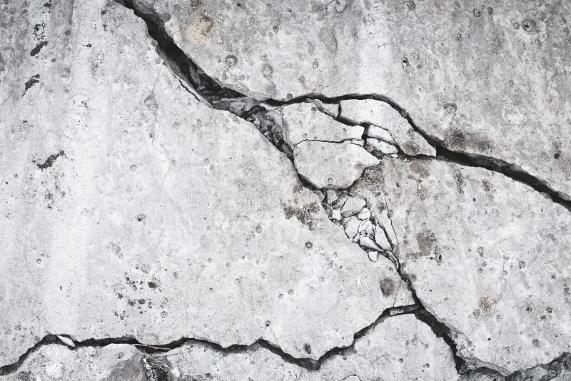 Ruined concrete wall, crack and hole in the cement slab. Grunge surface, danger concept. Damage effect, texture. Gray stone. Background, material stock photo