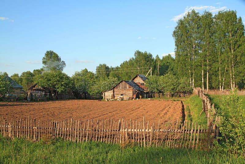 Rural house. Near plow field stock photo