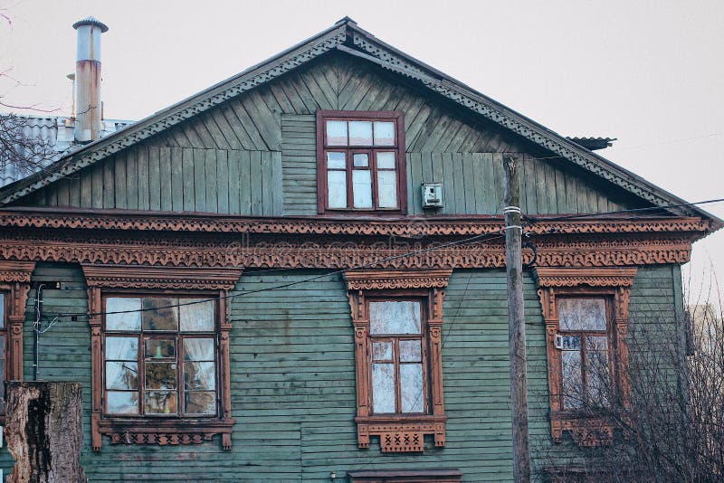Russian wooden house with carved platbands on the windows royalty free stock images