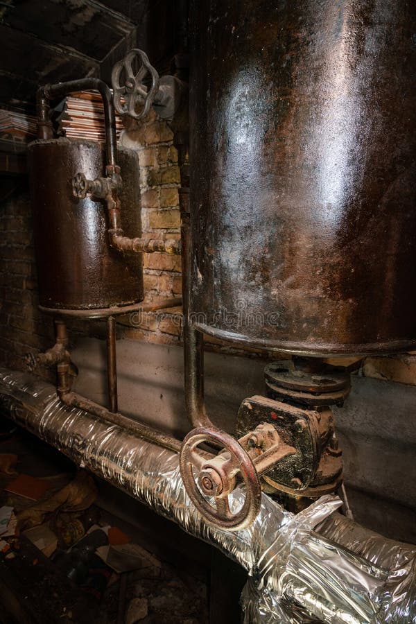 Rusty boiler room pipes. Old metal boiler generating heating and delivering it to home through pipeline. Hot water or gas is being. Delivered with this system stock photography