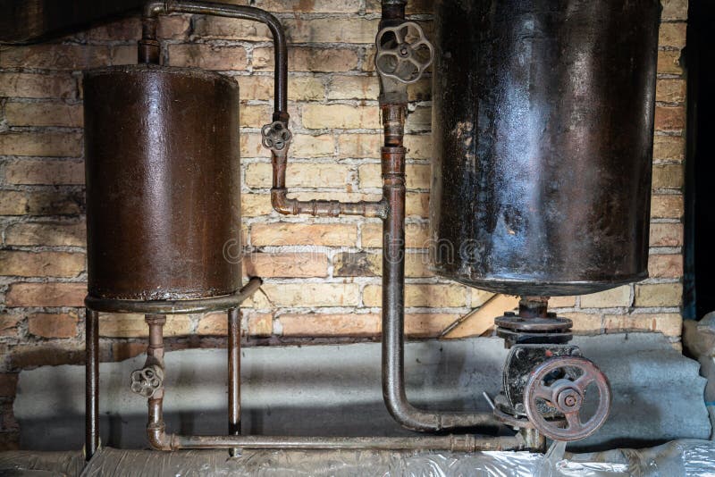 Rusty boiler room pipes. Old metal boiler generating heating and delivering it to home through pipeline. Hot water or gas is being. Delivered with this system royalty free stock images