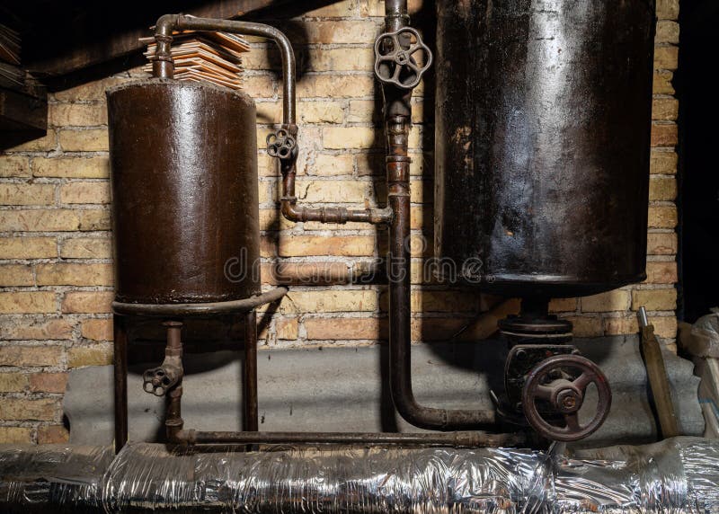 Rusty boiler room pipes. Old metal boiler generating heating and delivering it to home through pipeline. Hot water or gas is being. Delivered with this system royalty free stock photo