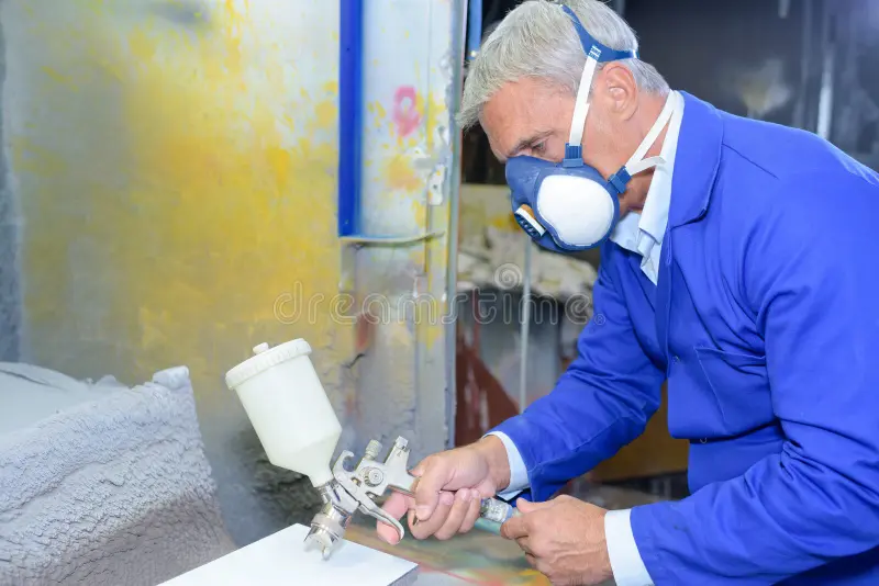 Senior painter wearing custom suit spray painting royalty free stock photos