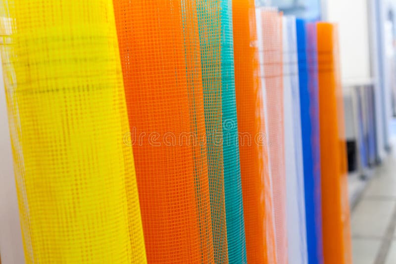 Set of fiberglass netting reinforcing mesh rolled up in a roll for the insulation of walls. A set of fiberglass netting reinforcing mesh rolled up in a roll for stock images