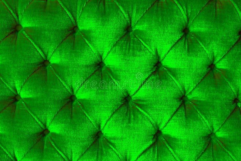 Shiny velvet light green sofa texture. Shiny light green velvet sofa with diamond shape texture with buttons stock image