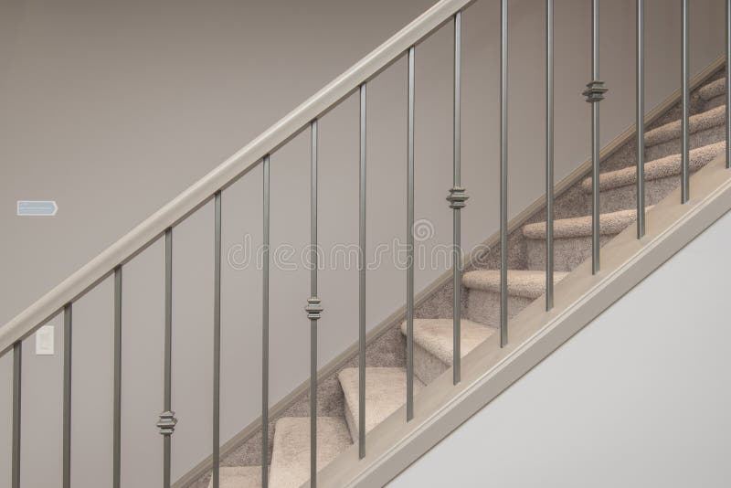 Shot of stairs inside of house with silver handrail. A shot of stairs inside of house with silver handrail royalty free stock images