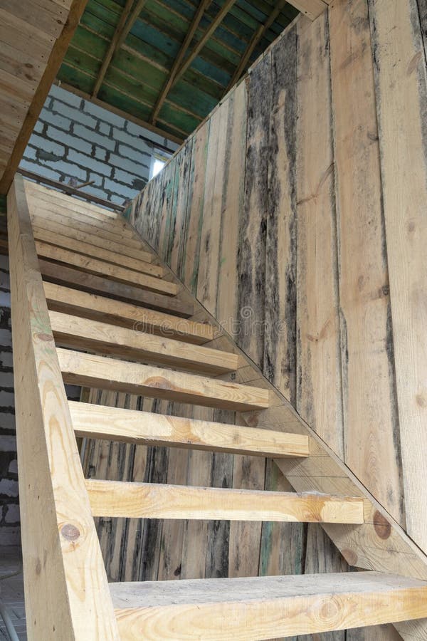 Simple cheap wooden staircase to the second floor stock image