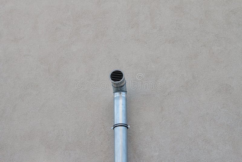 Single ventilation pipe on the wall of the house royalty free stock photography