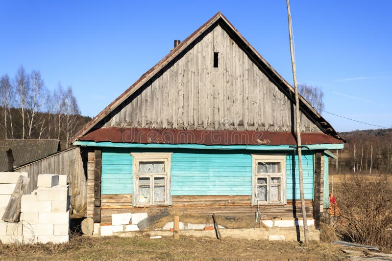 Small old wooden construction. shot on a bright sunny day. the house needs repairs. Text toning stock images