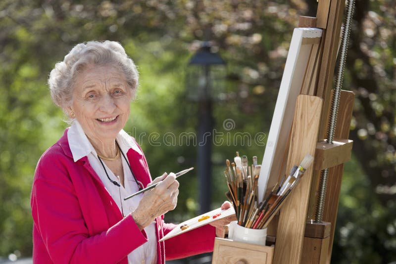 Smiling Senior Woman Painting stock photo