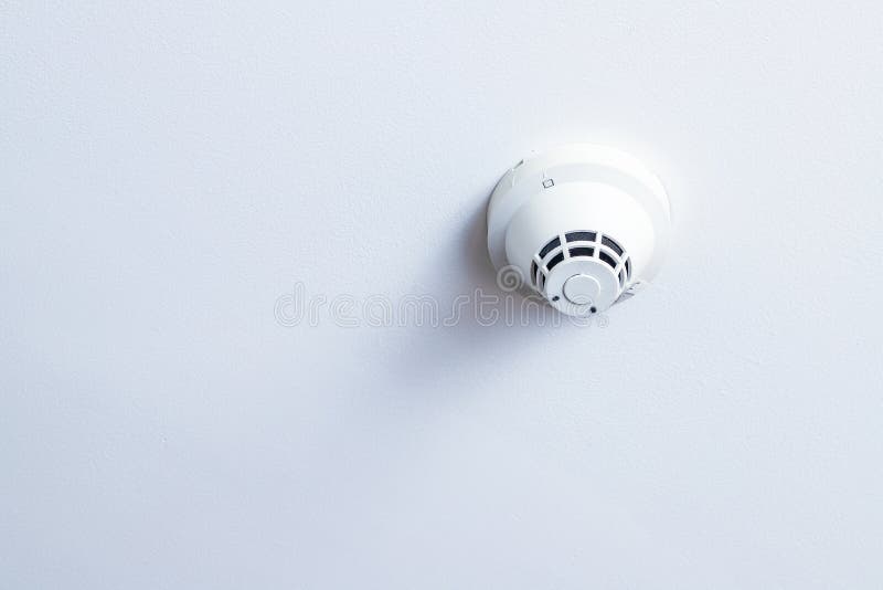 Smoke detector on white ceilings background. Room in house, with smoke detector on white ceilings background, selected focus on smoke detector stock photo