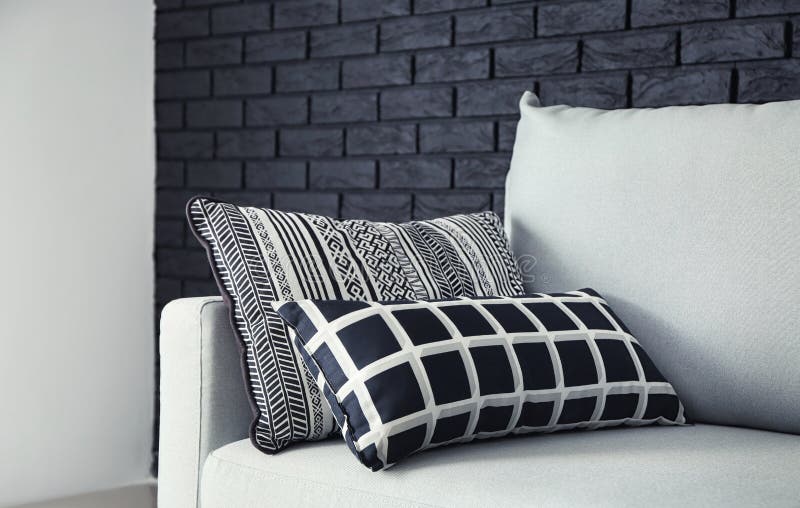 Soft pillows on light sofa indoors stock photos