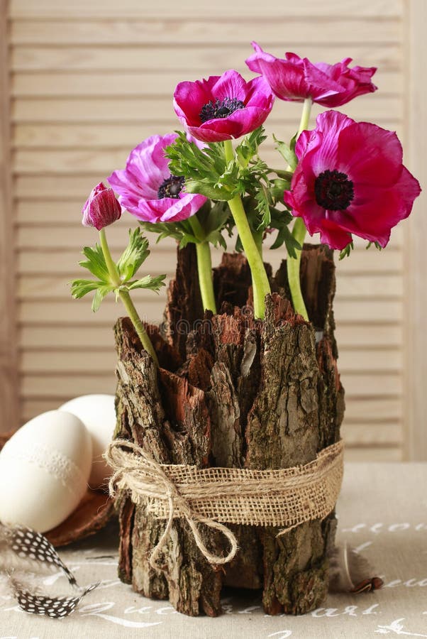 Spring table decoration with bark and anemone flowers. Party decor stock images