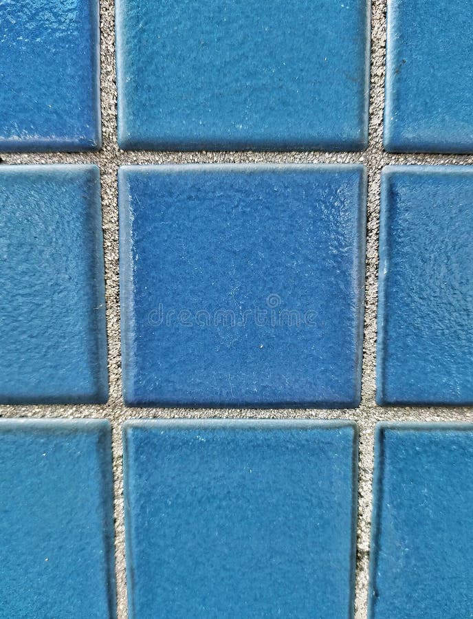 Square pattern blue tiled wall. Blue pool tiles. Dark blue small tiles on a wall. Facade of bathroom. Parede de azulejos azuis. Square pattern blue tiled wall stock images