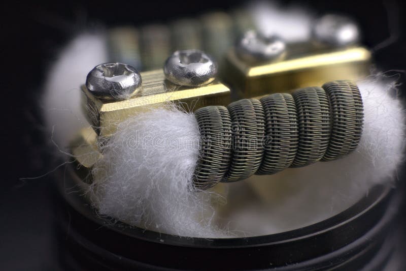 Staggerton fused clapton coil and cotton. Taggerton fused clapton coil for vaping and cotton stock images
