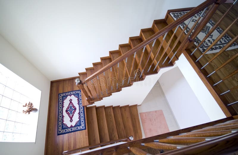 Stairs in modern house. A staircase of brown wooden stairs in a modern house royalty free stock image