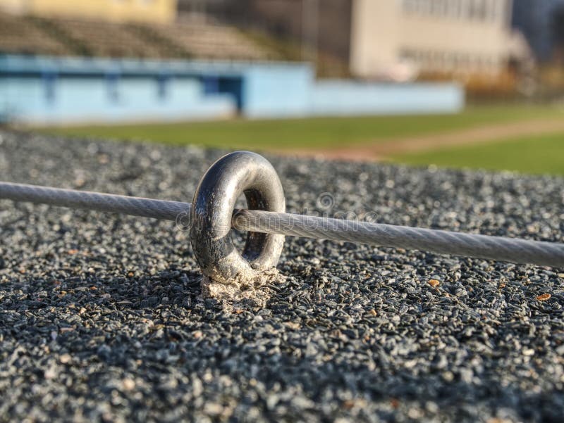 Steel twisted rope and bolt anchor eye in concrete. Steel twisted rope and steel bolt anchor eye in concrete base. The end knot of steel rope work wire weld wall royalty free stock photo