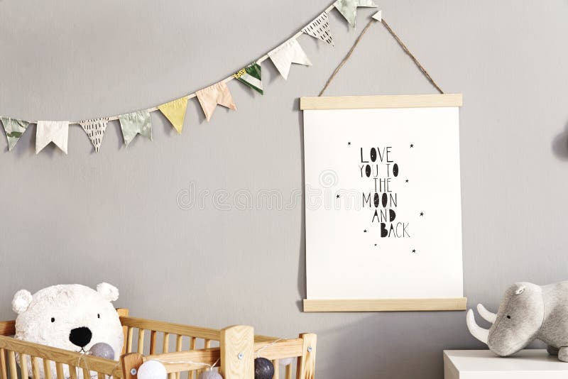 Stylish scandinavian nursery interior with hanging mock up poster, natural toys, teddy bears, children`s accessories and design stock photography