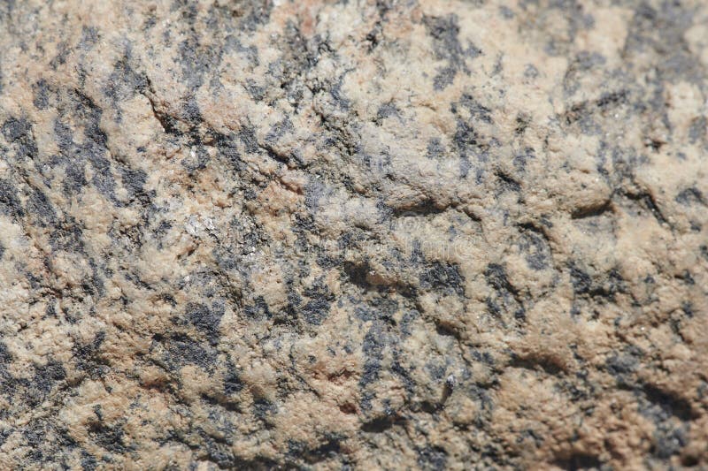 The surface of the chipped granite stone, rough, unpolished with multicolored splashes, natural, not treated, as a background for. The surface of the chipped royalty free stock photos