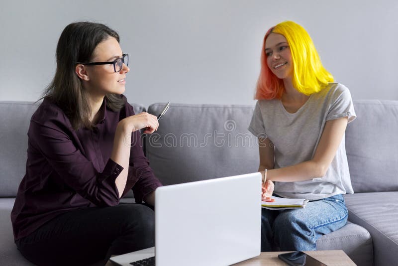 Teen student girl 15, 16 years old has individual lesson from young woman teacher.  stock image