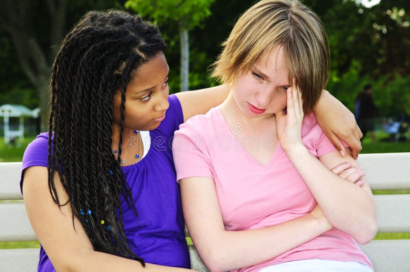 Teenager consoling her friend stock photography