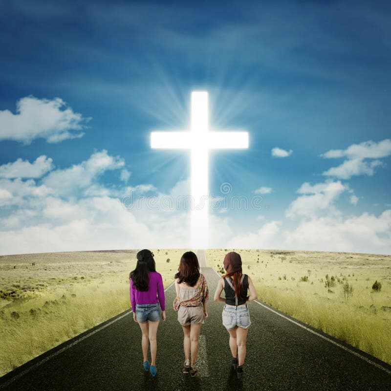 Teenager girls on the road with a cross stock photos