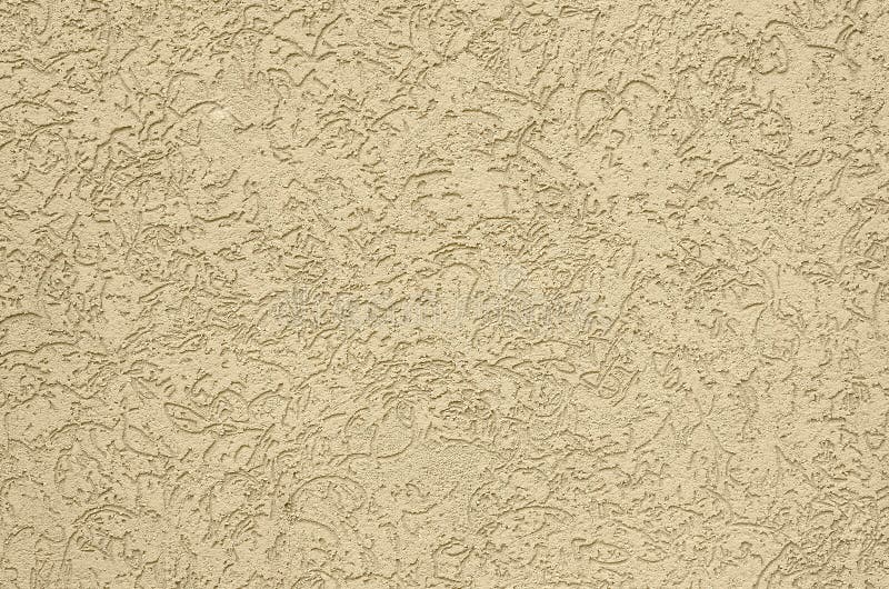 The texture of the beige decorative plaster in bark beetle style. Russian variation of decorating facade walls royalty free stock images