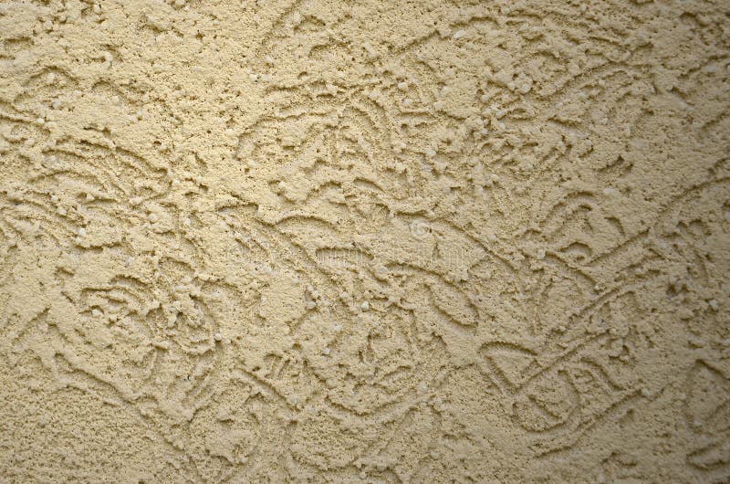 The texture of the beige decorative plaster in bark beetle style. Russian variation of decorating facade walls royalty free stock image