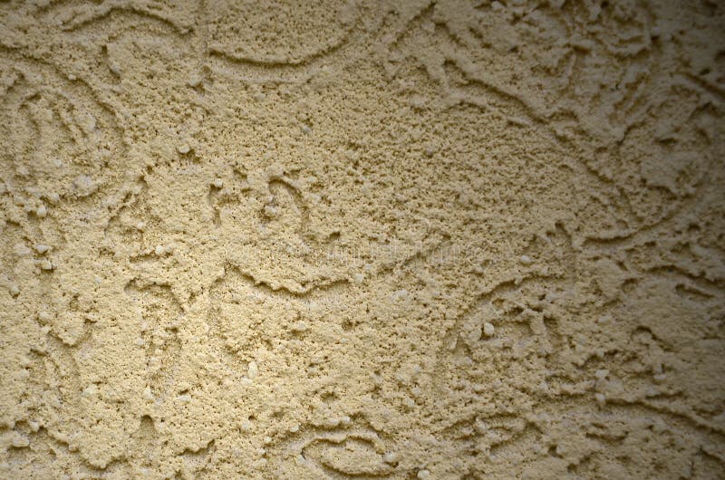 The texture of the beige decorative plaster in bark beetle style. Russian variation of decorating facade walls stock photography