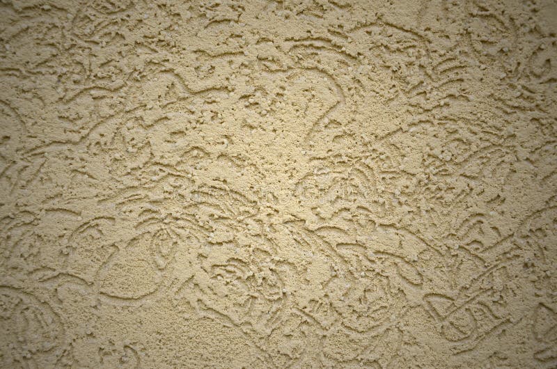 The texture of the beige decorative plaster in bark beetle style. Russian variation of decorating facade walls stock images