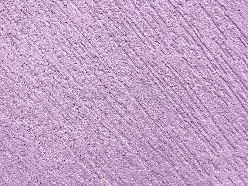 Texture decorative purple plaster imitating the old peeling wall. Texture decorative violet plaster imitating the old peeling wall. Obsolete lilac cracked royalty free stock photo