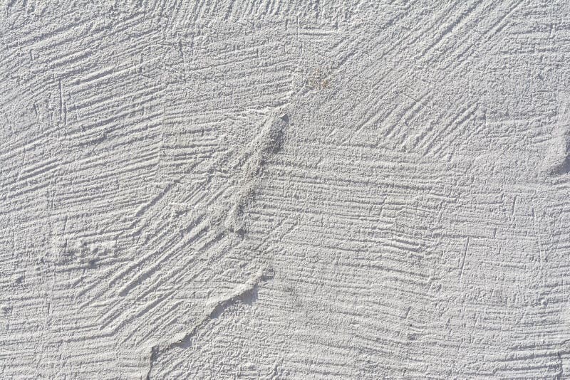 Texture of an embossed antique concrete wall with cracks and a ruined plaster protective layer. Abstract background stock photography