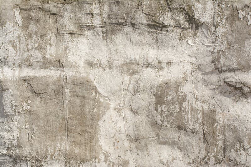 Texture of an embossed antique concrete wall with cracks and a ruined plaster protective layer. Abstract background stock photography