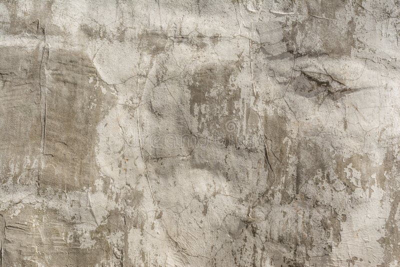 Texture of an embossed antique concrete wall with cracks and a ruined plaster protective layer. Abstract background royalty free stock photos
