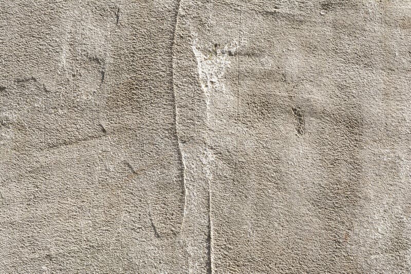 Texture of an embossed antique concrete wall with cracks and a ruined plaster protective layer. Abstract background stock images